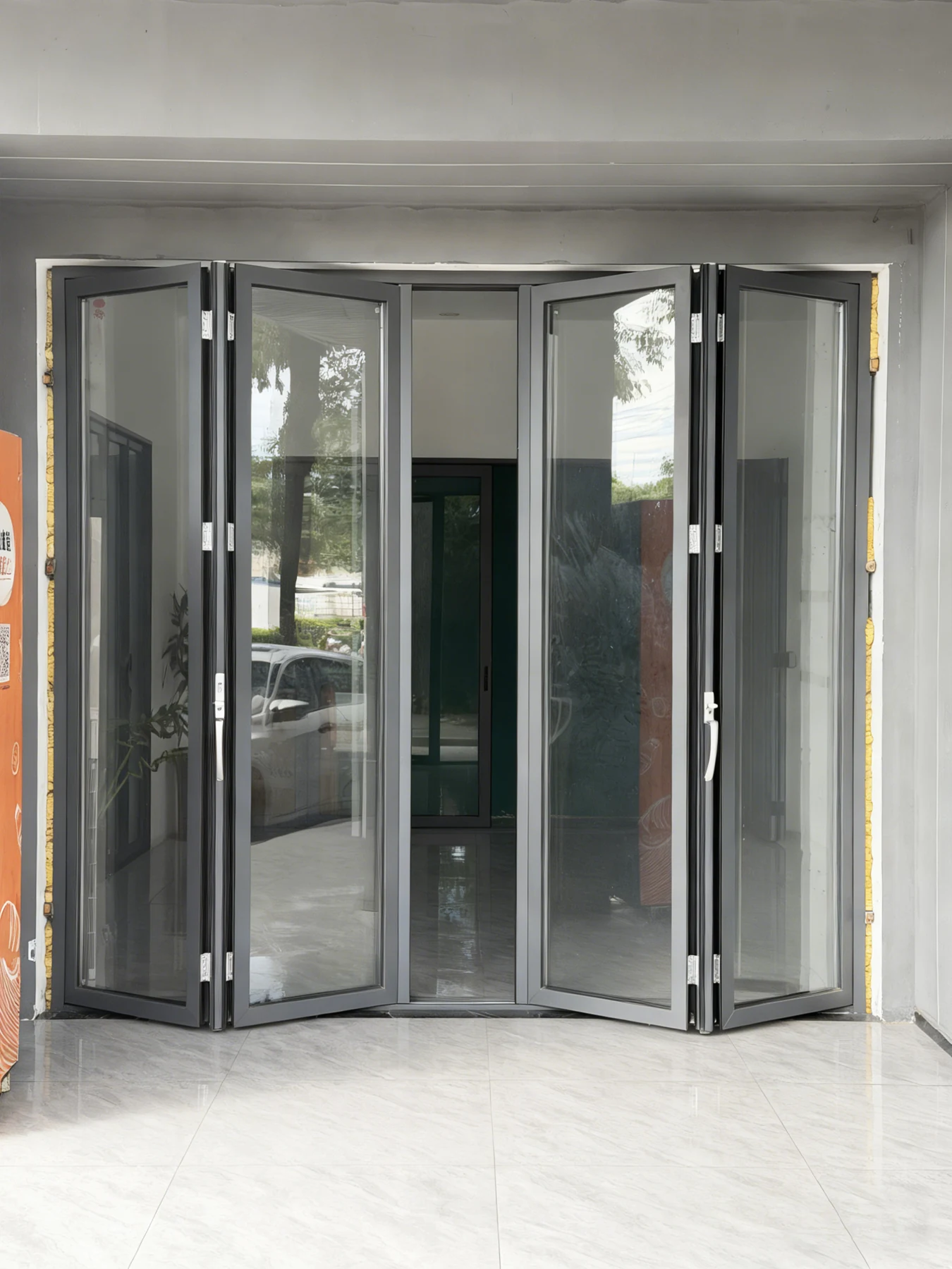 Wide grey folding glass-door entrance