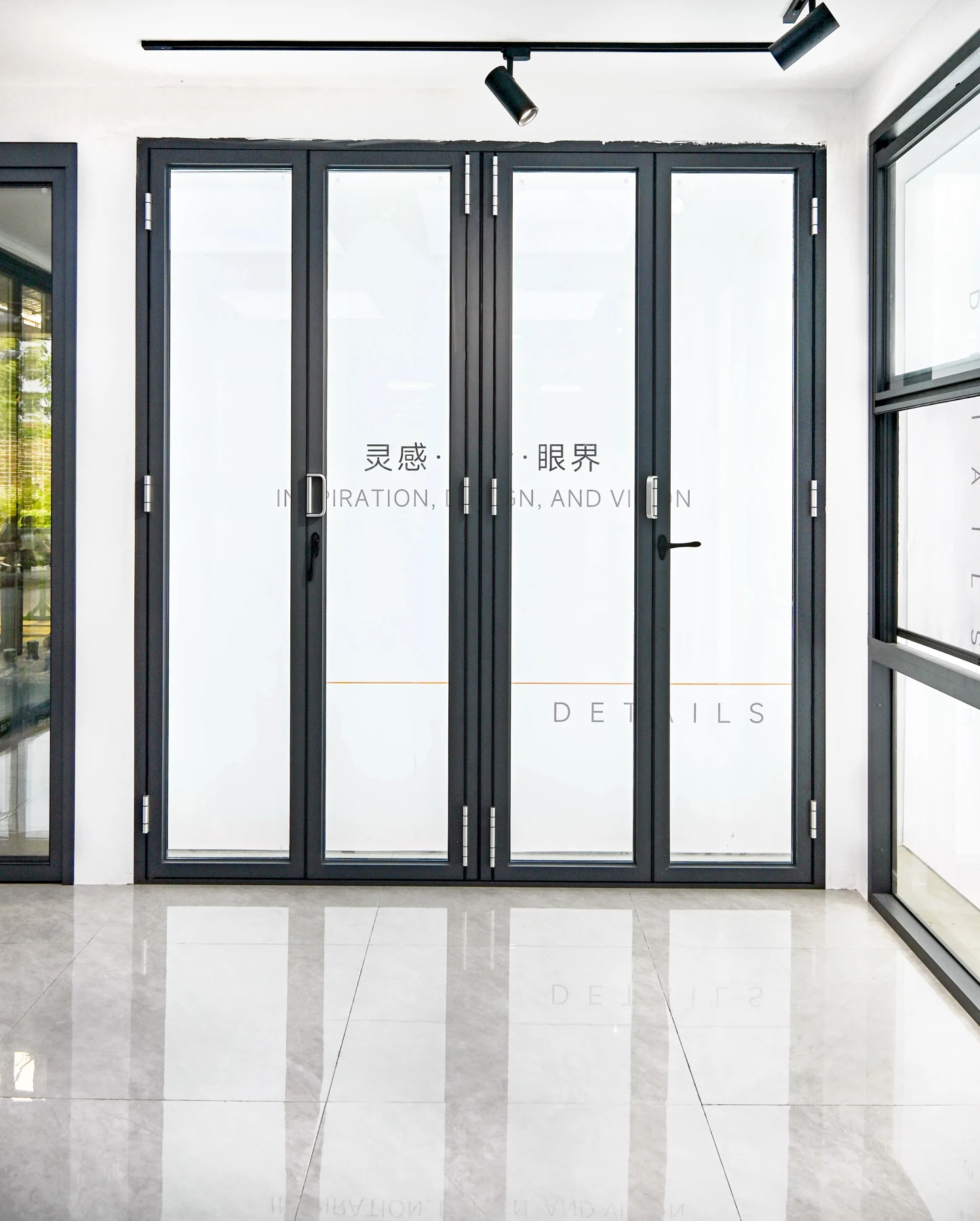 Dark multi-panel folding glass-door arrangement